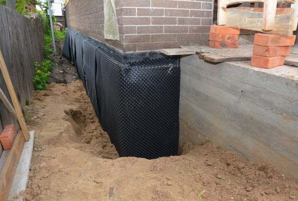 Happy homeowners after waterproofing job in Free Soil